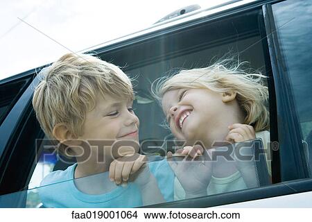Children sticking heads out of car window View Large Photo Image Picture - Children sticking heads out of car window. Fotosearch