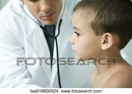 Doctor leaning toward boy with stethoscope View Large Photo Image Picture - Doctor leaning toward boy with stethoscope. Fotosearch