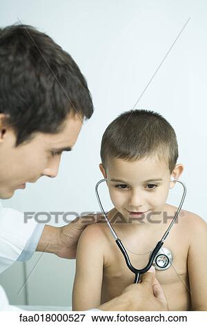 Stock Photo - Doctor letting boy listen to own chest with stethoscope. Fotosearch