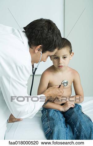 Doctor listening to boy's chest with stethoscope View Large Photo Image Stock Image - Doctor listening to boy's chest with stethoscope. Fotosearch