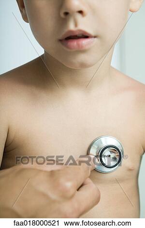 Doctor listening to boy's chest with stethoscope, close-up View Large Photo Image Stock Image - Doctor listening to boy's chest with stethoscope, close-up. Fotosearch