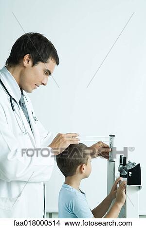 Doctor measuring boy during check-up View Large Photo Image Picture - Doctor measuring boy during check-up. Fotosearch