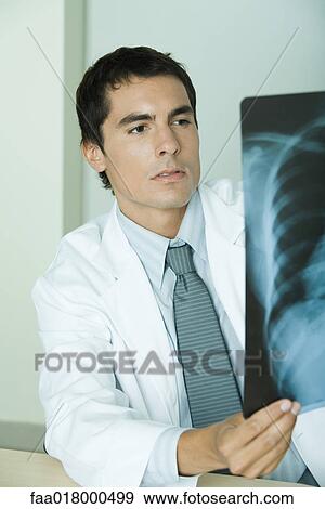 Stock Photo - Doctor studying x-ray. Fotosearch