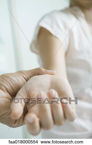 Doctor taking woman's pulse, close-up View Large Photo Image Picture - Doctor taking woman's pulse, close-up. Fotosearch