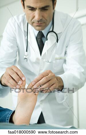 Doctor touching child's toes View Large Photo Image Stock Image - Doctor touching child's toes. Fotosearch