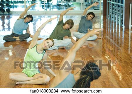 Picture - Exercise class doing seated side bend. Fotosearch