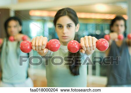 Exercise class working out with dumbbells View Large Photo Image Picture - Exercise class working out with dumbbells. Fotosearch