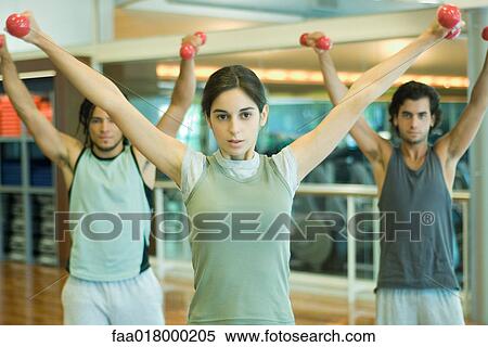 Stock Photography - Exercise class working out with dumbbells. Fotosearch