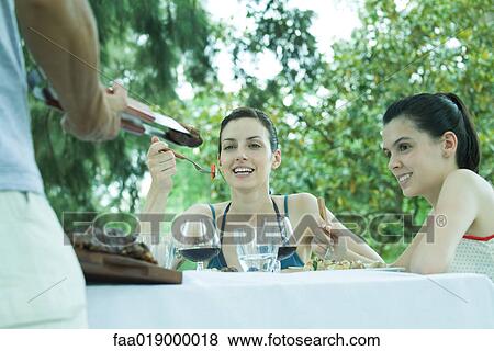 Family eating outdoors View Large Photo Image Stock Photo - Family eating outdoors. Fotosearch
