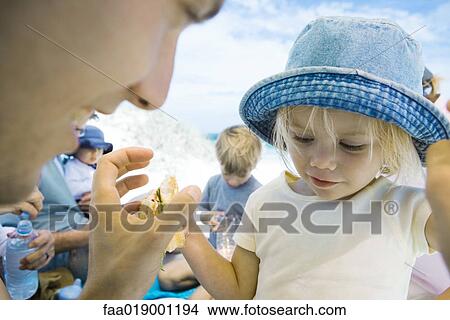 Picture - Family having picnic on beach. Fotosearch