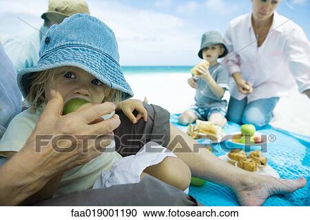 Family having picnic on beach View Large Photo Image Stock Image - Family having picnic on beach. Fotosearch