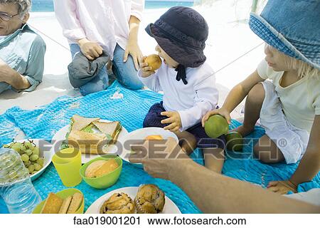 Family having picnic on beach View Large Photo Image Stock Image - Family having picnic on beach. Fotosearch