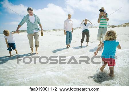 Stock Image - Family on beach. Fotosearch