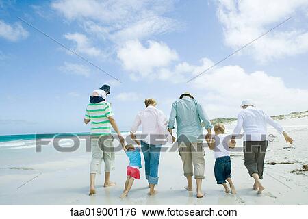 Stock Photograph - Family on beach. Fotosearch