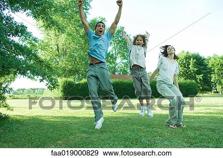 Family outdoors, jumping into the air View Large Photo Image Stock Photo - Family outdoors, jumping into the air. Fotosearch