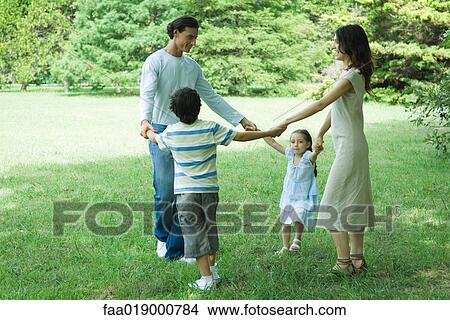 Family outdoors playing ring-around-the-rosy View Large Photo Image Picture - Family outdoors playing ring-around-the-rosy. Fotosearch