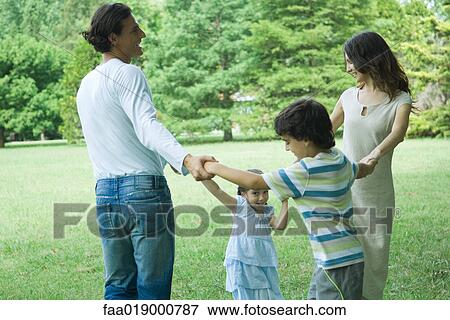 Family outdoors playing ring-around-the-rosy View Large Photo Image Stock Photo - Family outdoors playing ring-around-the-rosy. Fotosearch
