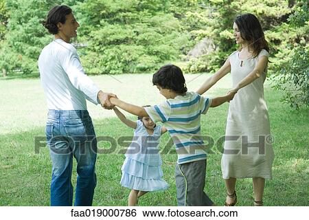 Family outdoors playing ring-around-the-rosy View Large Photo Image Stock Photograph - Family outdoors playing ring-around-the-rosy. Fotosearch