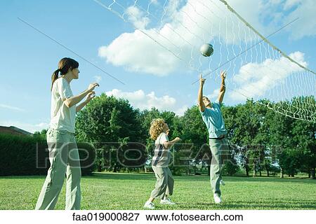 Family outdoors playing volleyball View Large Photo Image Stock Photo - Family outdoors playing volleyball. Fotosearch