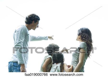 Family outdoors, pointing to sky, low angle view View Large Photo Image Stock Photograph - Family outdoors, pointing to sky, low angle view. Fotosearch