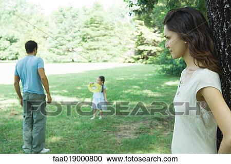 Stock Image - Family playing outdoors. Fotosearch