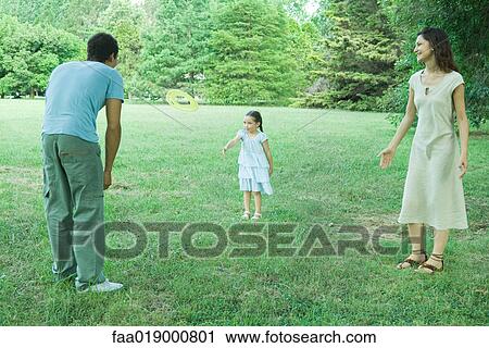Family playing with plastic disc outdoors View Large Photo Image Stock Image - Family playing with plastic disc outdoors. Fotosearch