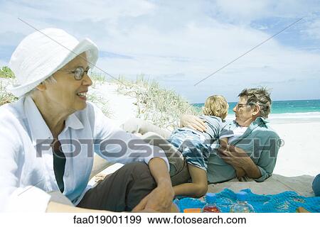 Stock Photo - Family relaxing on beach. Fotosearch