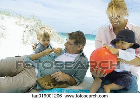 Family relaxing on beach View Large Photo Image Stock Photograph - Family relaxing on beach. Fotosearch