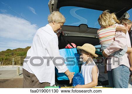 Family unloading car View Large Photo Image Stock Image - Family unloading car. Fotosearch