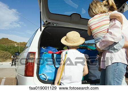 Family unloading car View Large Photo Image Stock Photo - Family unloading car. Fotosearch