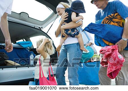 Family unloading trunk of car View Large Photo Image Stock Image - Family unloading trunk of car. Fotosearch
