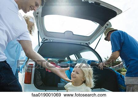 Family unloading trunk of car View Large Photo Image Stock Photo - Family unloading trunk of car. Fotosearch