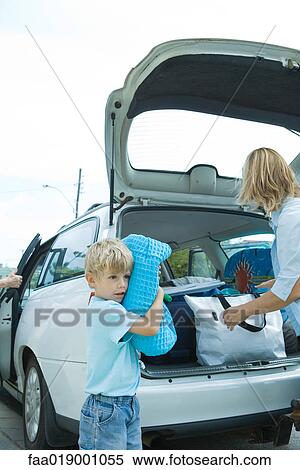 Family unloading trunk of car View Large Photo Image Stock Photography - Family unloading trunk of car. Fotosearch