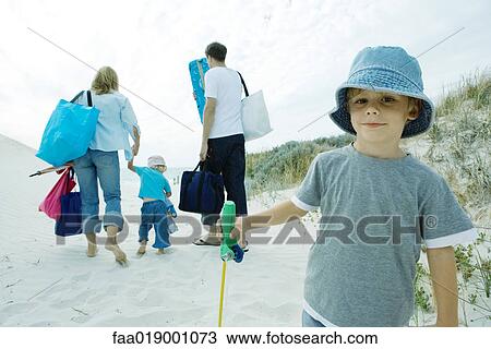 Family walking through dunes to beach View Large Photo Image Stock Image - Family walking through dunes to beach. Fotosearch