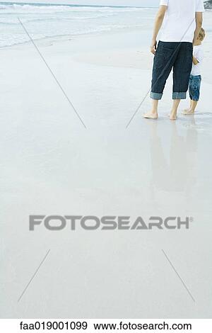 Father and child standing on beach View Large Photo Image Stock Photo - Father and child standing on beach. Fotosearch