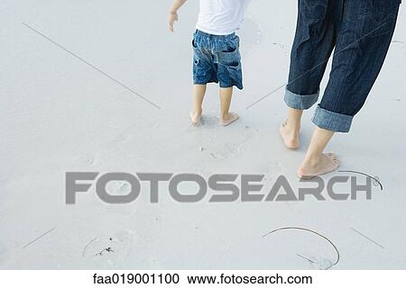Father and child walking on beach View Large Photo Image Stock Image - Father and child walking on beach. Fotosearch
