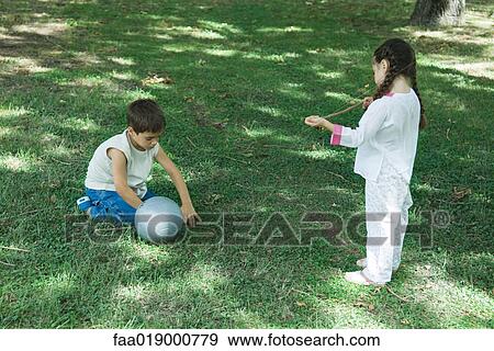 Girl and boy playing with ball View Large Photo Image Stock Photo - Girl and boy playing with ball. Fotosearch
