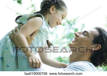 Girl and father, man lifting girl into the air View Large Photo Image Stock Photograph - Girl and father, man lifting girl into the air. Fotosearch