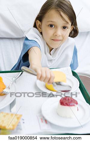 Girl eating meal in hospital bed View Large Photo Image Picture - Girl eating meal in hospital bed. Fotosearch