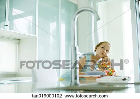Girl eating sweets and doing homework View Large Photo Image Stock Image - Girl eating sweets and doing homework. Fotosearch