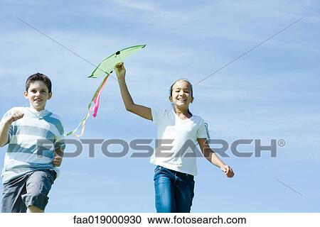 Girl holding up kite View Large Photo Image Stock Image - Girl holding up kite. Fotosearch