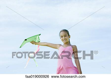 Girl holding up kite View Large Photo Image Stock Photograph - Girl holding up kite. Fotosearch