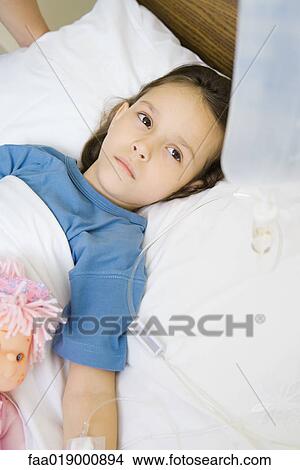 Girl lying in hospital bed View Large Photo Image Picture - Girl lying in hospital bed. Fotosearch