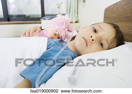 Girl lying in hospital bed View Large Photo Image Stock Image - Girl lying in hospital bed. Fotosearch