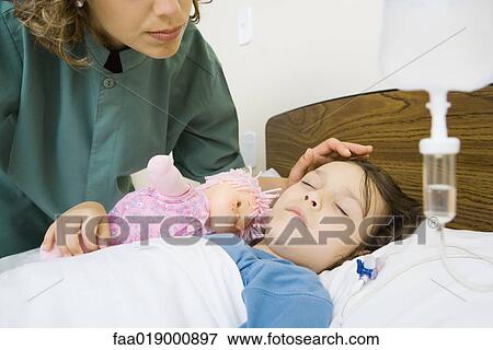 Girl lying in hospital bed View Large Photo Image Stock Photo - Girl lying in hospital bed. Fotosearch