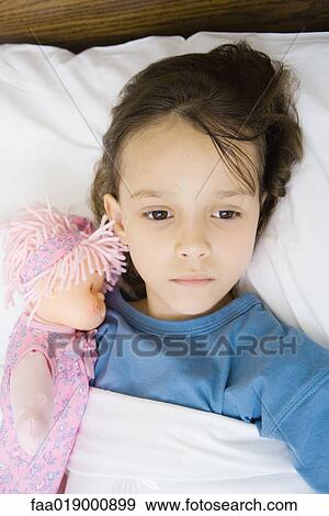 Girl lying in hospital bed View Large Photo Image Stock Photo - Girl lying in hospital bed. Fotosearch