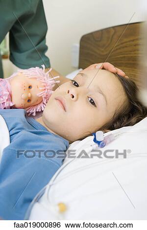 Girl lying in hospital bed View Large Photo Image Stock Photograph - Girl lying in hospital bed. Fotosearch