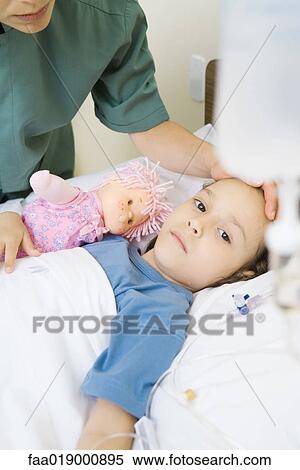 Girl lying in hospital bed View Large Photo Image Stock Photography - Girl lying in hospital bed. Fotosearch