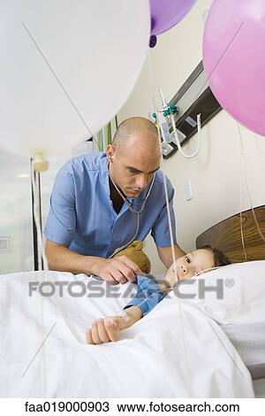 Girl lying in hospital bed, surrounded by balloons View Large Photo Image Stock Image - Girl lying in hospital bed, surrounded by balloons. Fotosearch