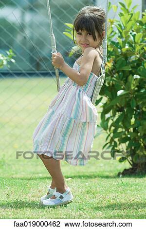 Girl sitting on swing View Large Photo Image Stock Image - Girl sitting on swing. Fotosearch